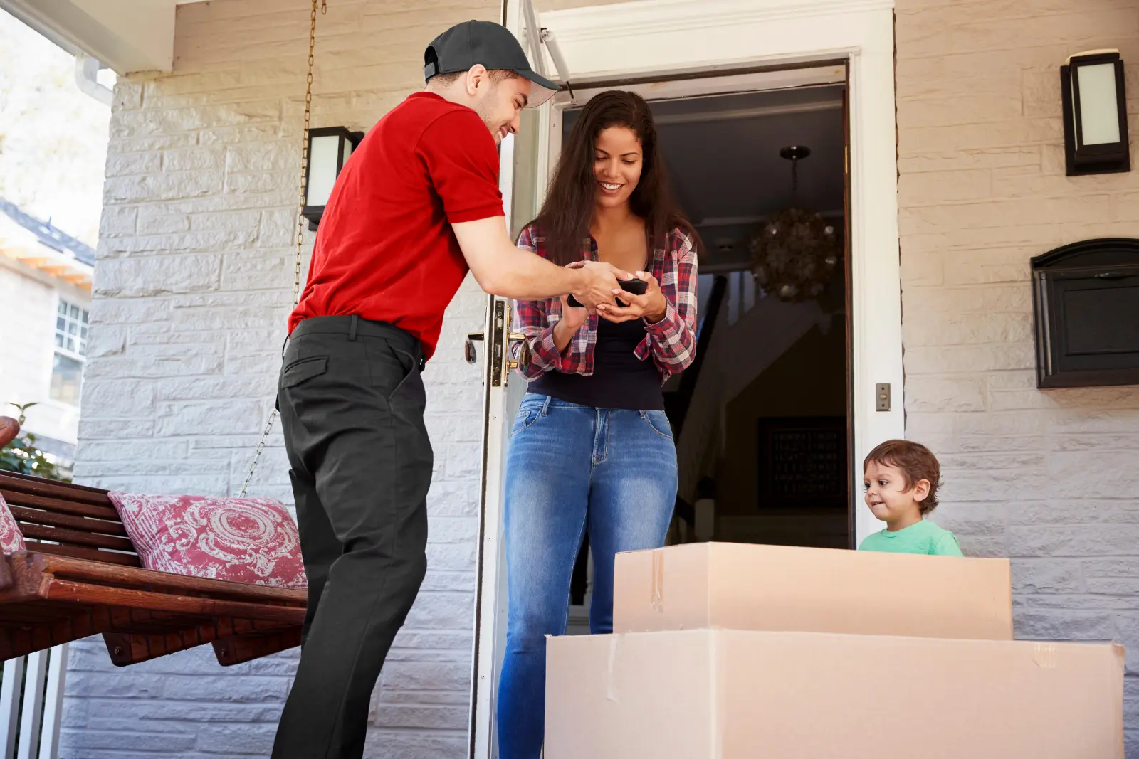 A Desert Moving crew member showing a homeowner a tablet at her front door